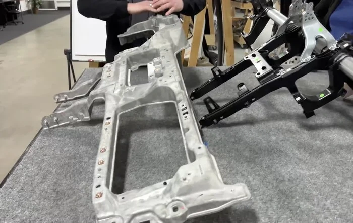 How to adhere things to steel?  Via crossbar beam - Ford's method vs Tesla's (Sandy Munro video)