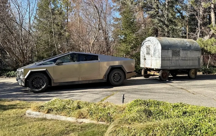 Future meets the past. Cybertruck tows vintage sheep camp trailer.