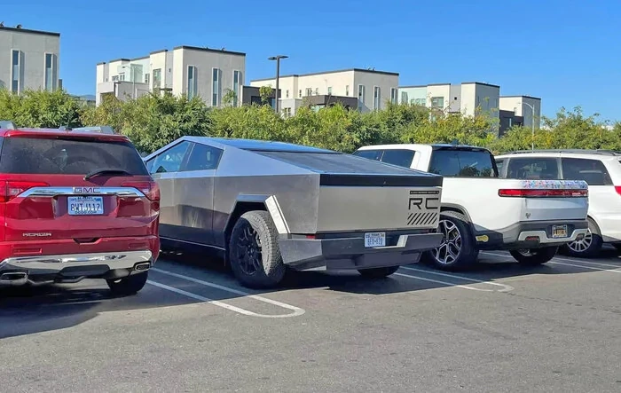 Cybertruck parked next to Rivian R1T and driving next to R1S