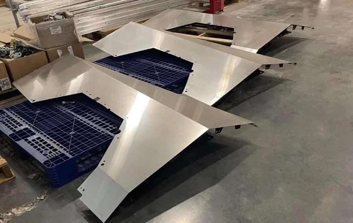 Unassembled fender quarter panels stainless steel parts on Giga Texas factory floor